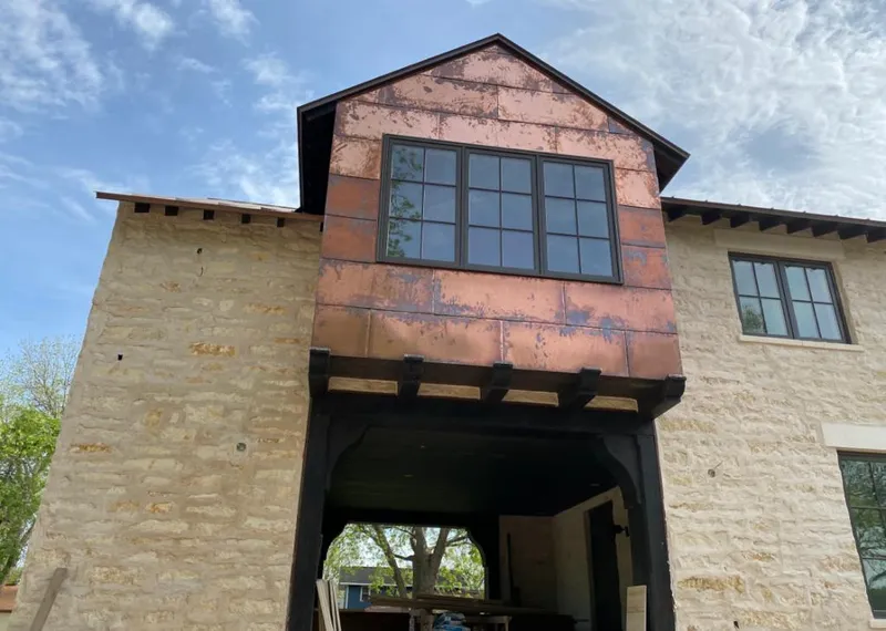 Copper metal panel facade on a stone building for Skylight Installation in Soledad
