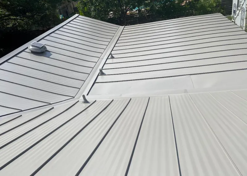 Solar attic fan installed on a metal roof for Roof Ventilation in Soledad